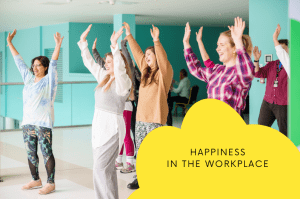 4 women with hands in the air laughing for happiness in the workplace