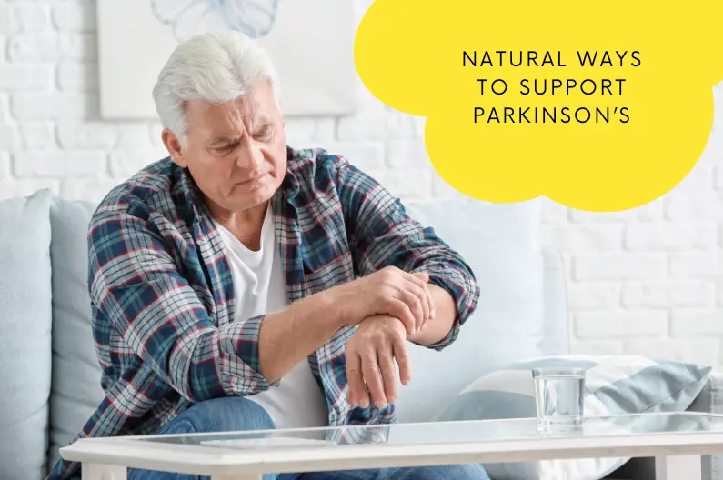 Man with Parkinson's disease experiencing tremor symptoms while seated at home, illustrating the need for natural support methods like Laughter Yoga