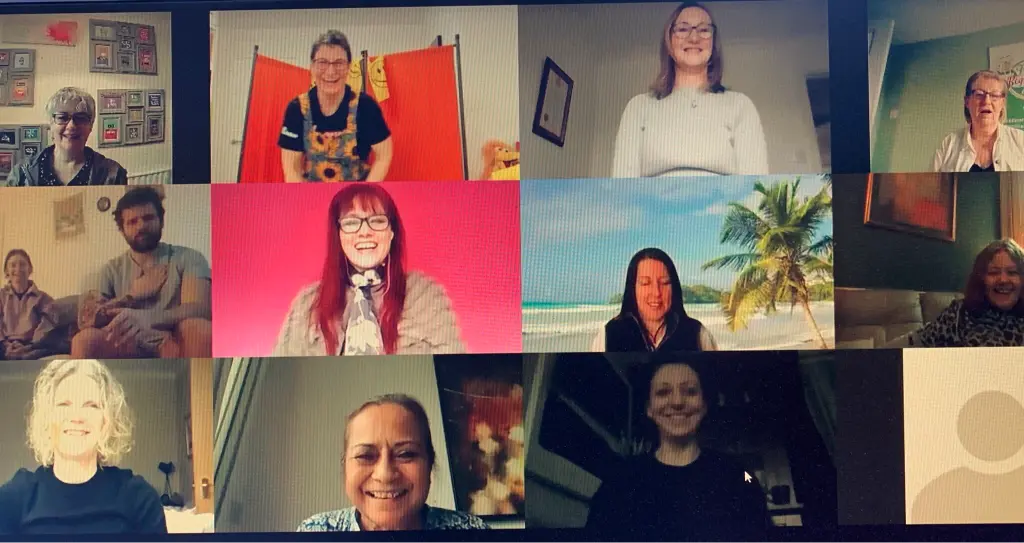 Remote working and loneliness eased by a team laughing together on a video call