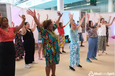 Participants laughing, dancing and playing together during a Laughter Yoga session with Serious Laughter - experiencing the four elements of joy