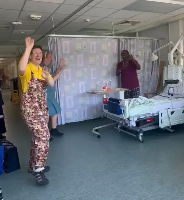 Does laughter yoga really work? A Serious Laughter session on a hospital ward shows a facilitator laughing and clapping with patients and staff.