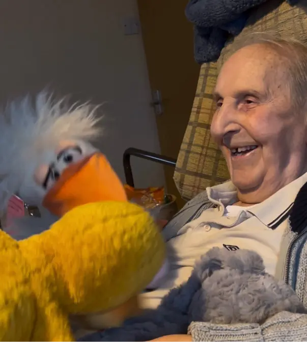 Older woman smiling and laughing during a gentle activity